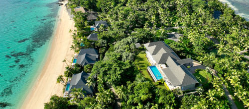 A birds eye view of beachfront villas and a luxury residence set atop the hill at Kokomo Private Island Fiji