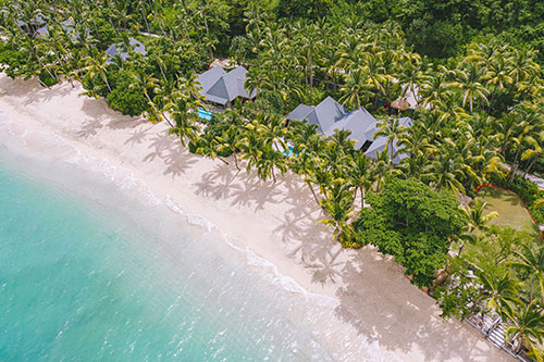 Beachfront villas at Kokomo Private Island Fiji viewed from the water